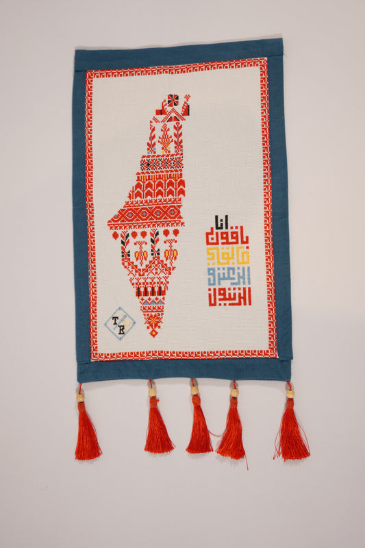 Handmade embroidered Mo’allaqa wall hanging with the map of Palestine in red tatreez patterns, crafted by Palestinian women artisans.