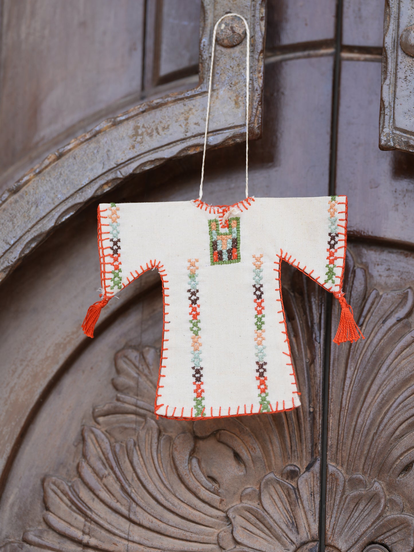Miniature handmade Palestinian thoub ornament with traditional tatreez embroidery in beige, orange, and multicolor, cultural decor for car or home