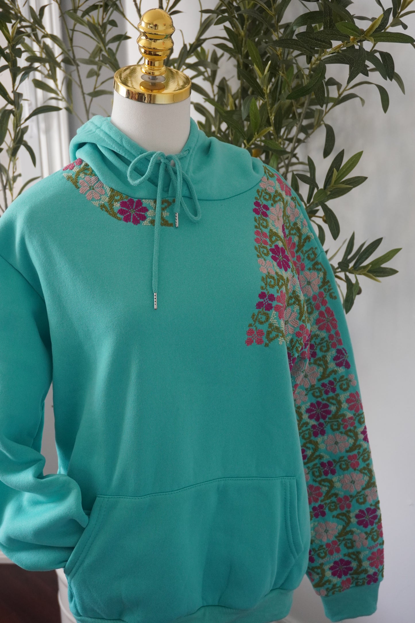 Bright green medium hoodie featuring unique embroidered flowers, showcasing handmade artistry"