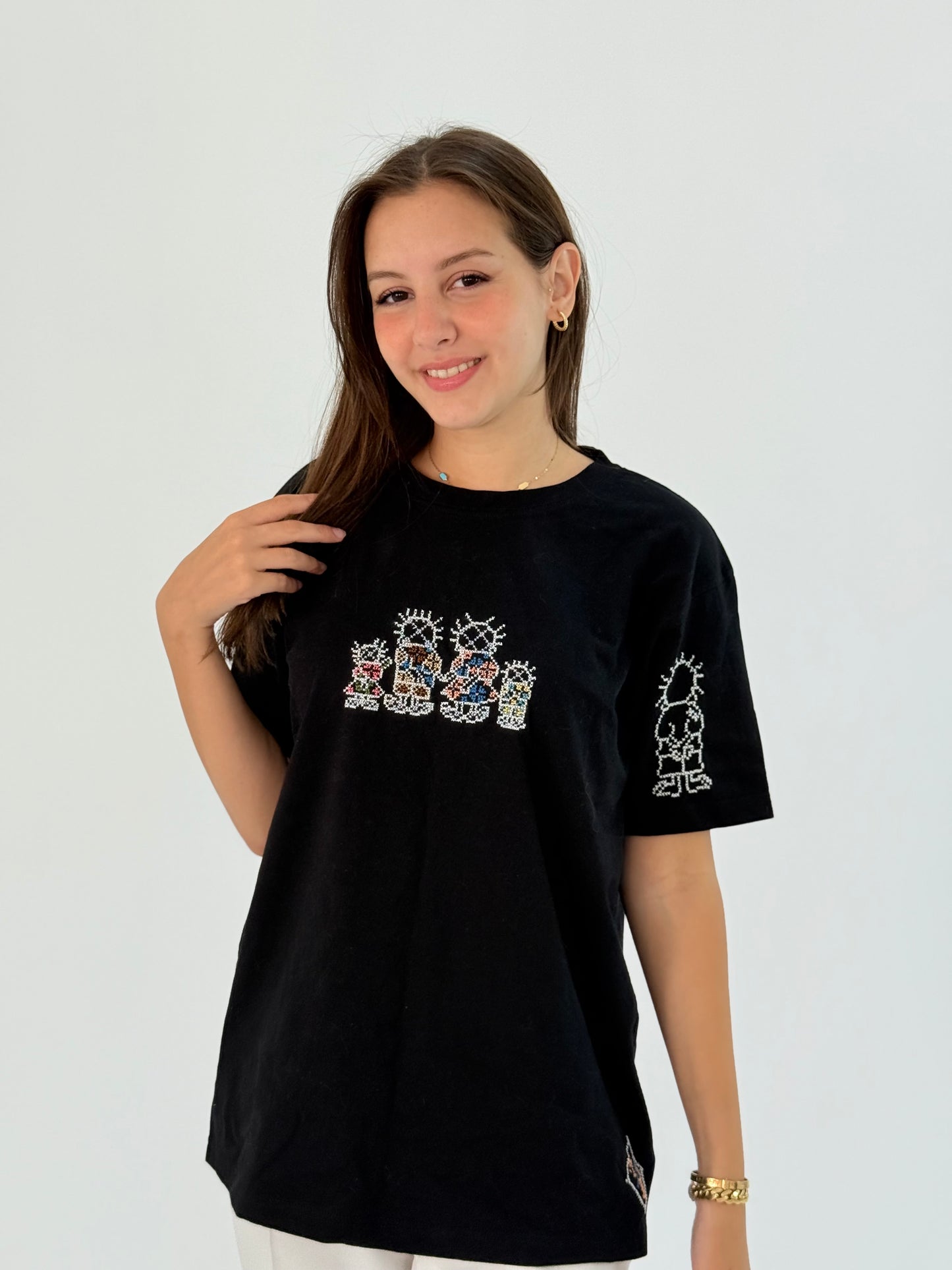 Handmade black cotton t-shirt with a small font Handhala design, offering understated cultural expression.