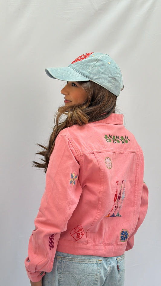 Handmade pink jeans jacket featuring Palestinian heritage motifs, modeled in large size, showcasing cultural craftsmanship