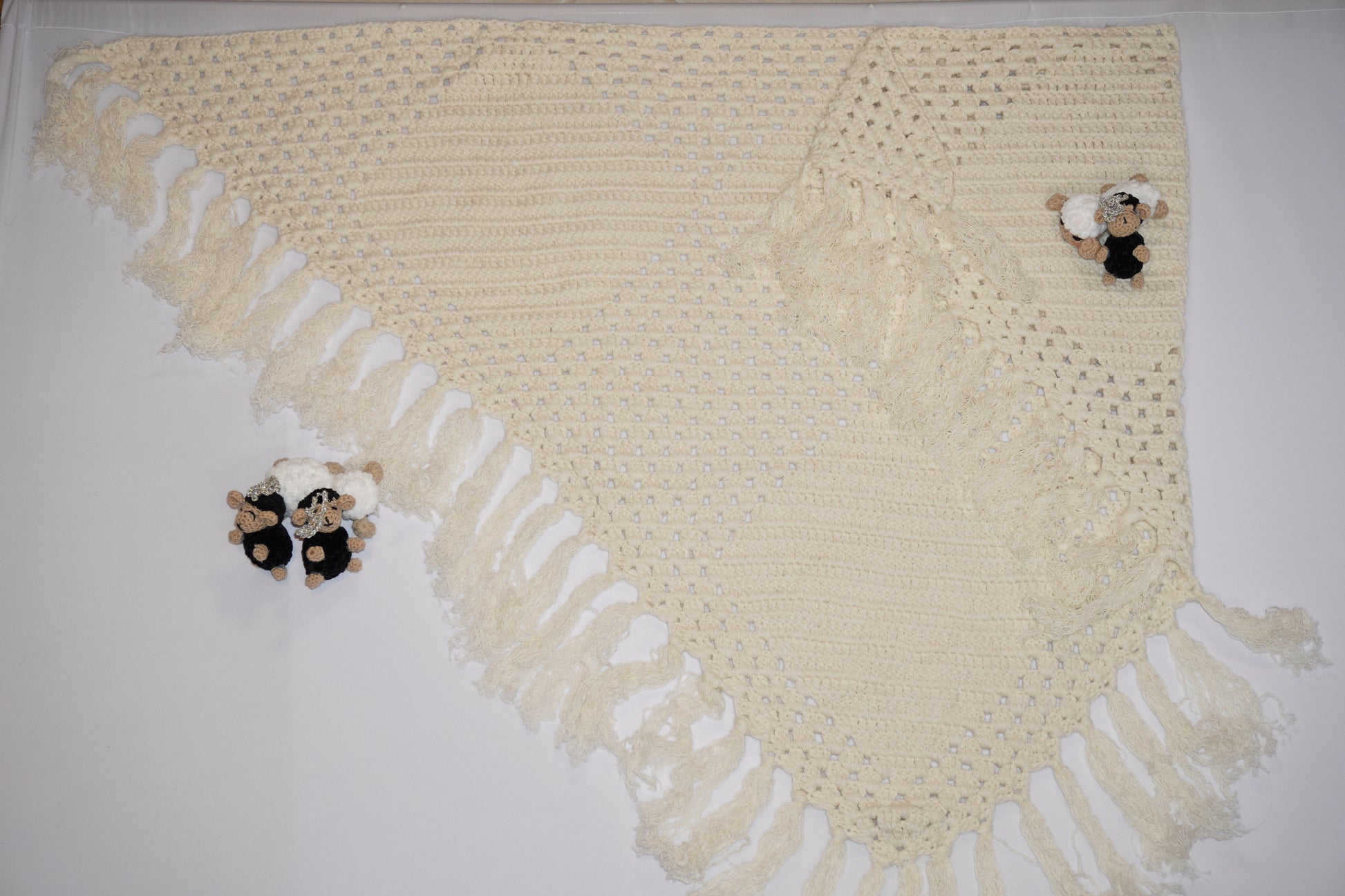 Handmade off-white crochet shawl with fringe edges, crafted with wool and cotton blend, traditional Middle Eastern design