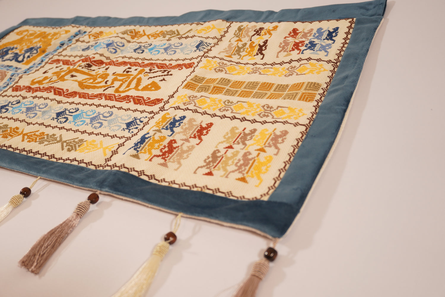 Handmade embroidered Islamic Mo’allaqa wall hanging with Arabic calligraphy “This is by the Grace of My Lord,” made by Palestinian women artisans.
