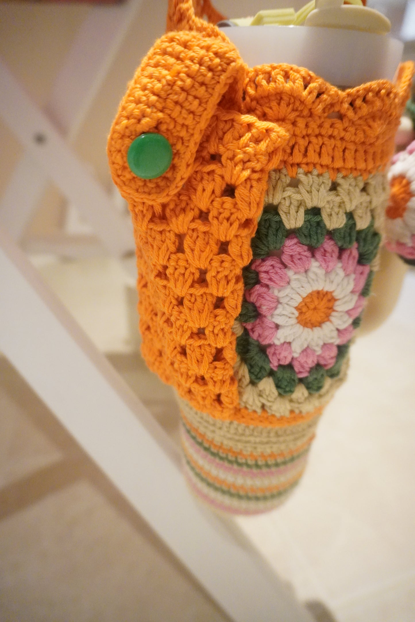 Handmade Crochet Stanley Bottle Cover – Beige with Yellow Flowers, Pocket & Carry Strap | Fits 30ozHandmade Crochet Stanley Bottle Cover – Orange Flowers with Green and White Combination | Fits 30oz
