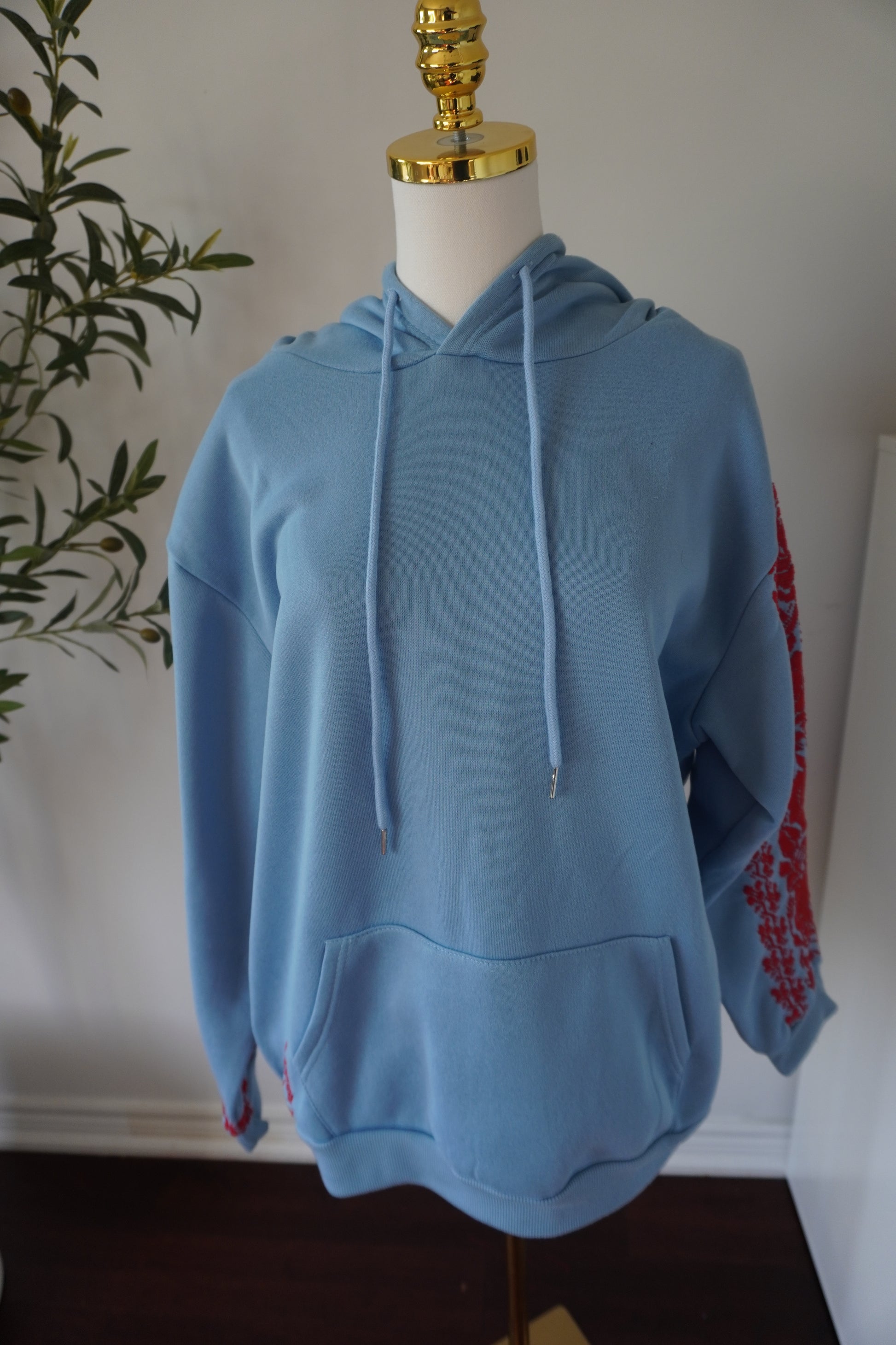 Light blue cotton hoodie with red embroidery, handmade in Ramallah