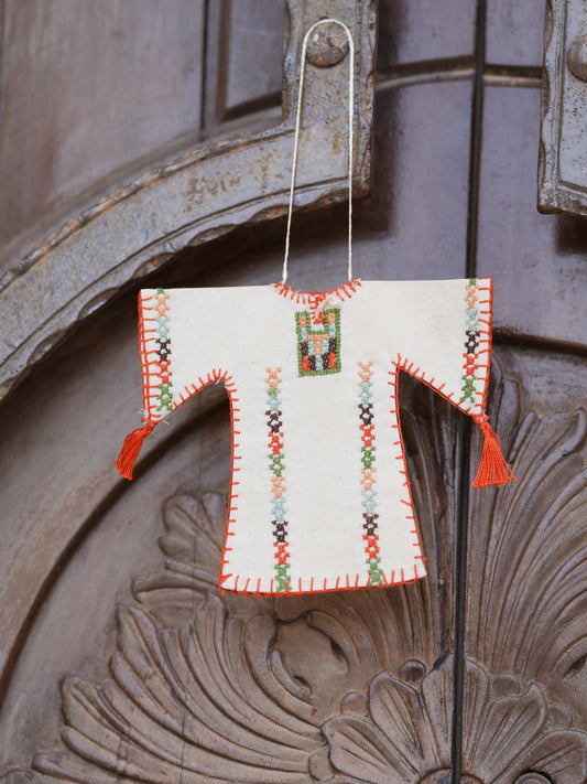 Miniature handmade Palestinian thoub ornament with traditional tatreez embroidery in beige, orange, and multicolor, cultural decor for car or home
