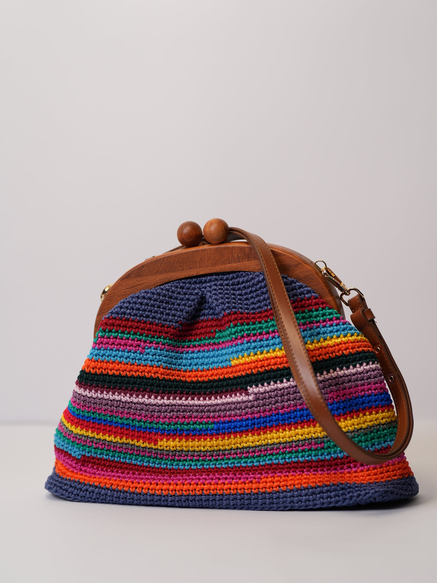 Handmade colourful rainbow crochet bag with leather strap by women artisans. 