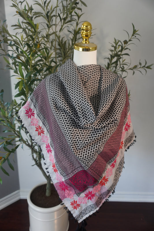 A very light and elegant kofea in soft pink with handmade tatreez embroidery in shades of pink, highlighting the intricate craftsmanship and sophisticated design of the piece."
