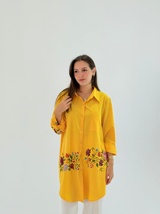 Handmade yellow shirt made of polin fabric with elegant floral embroidery on the bottom.
