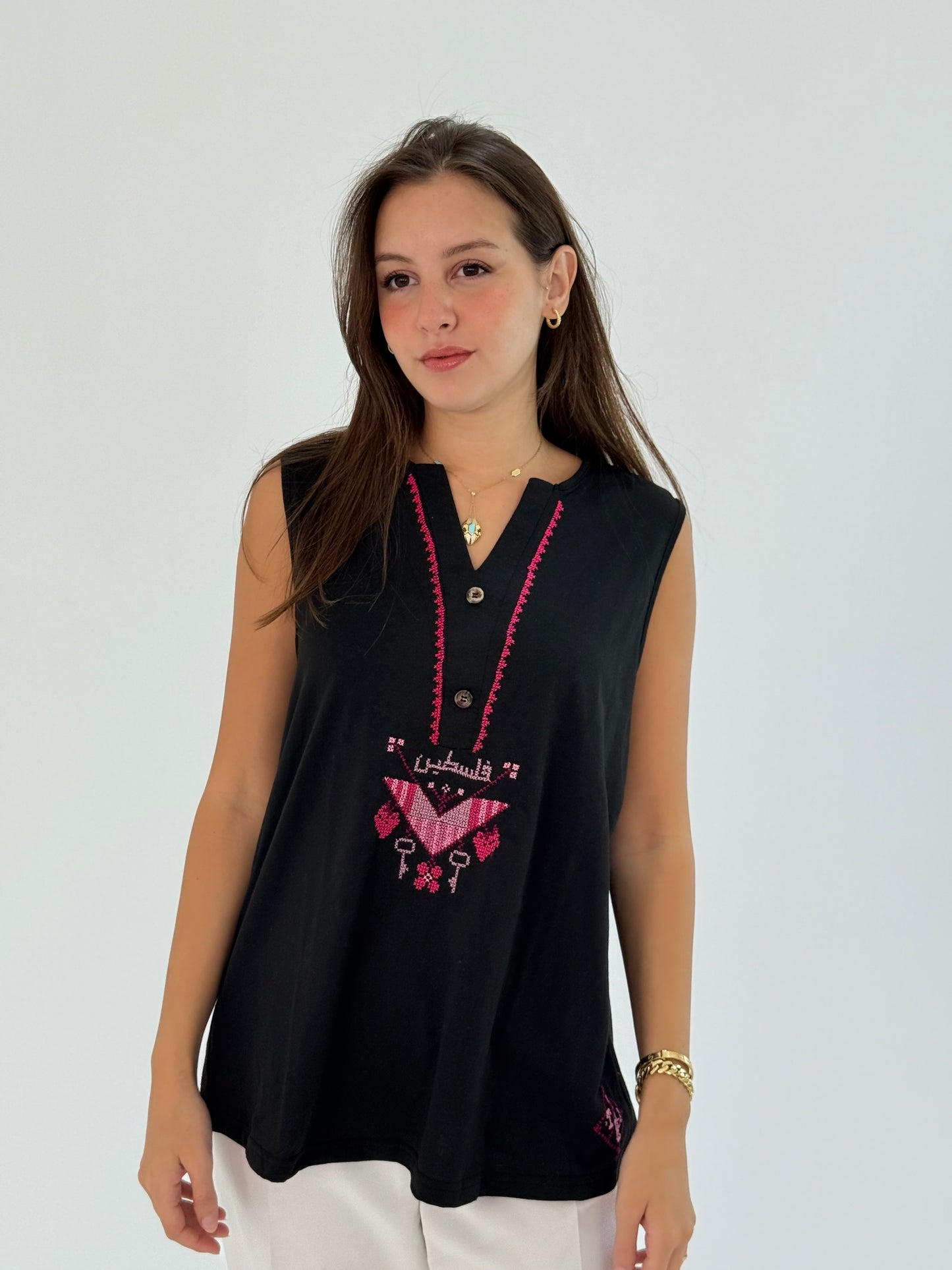 Black cotton cut top with 'Palestine' embroidered in Arabic on the front, offering a stylish and elegant design.