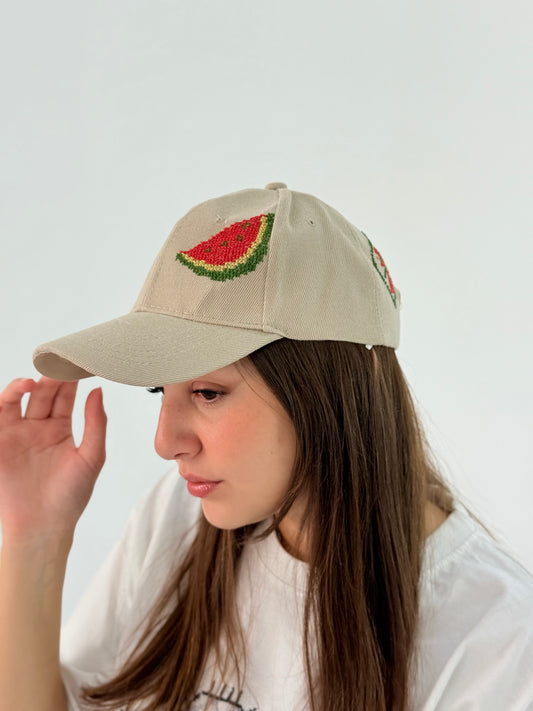 Beige cap hat with an embroidered watermelon design.