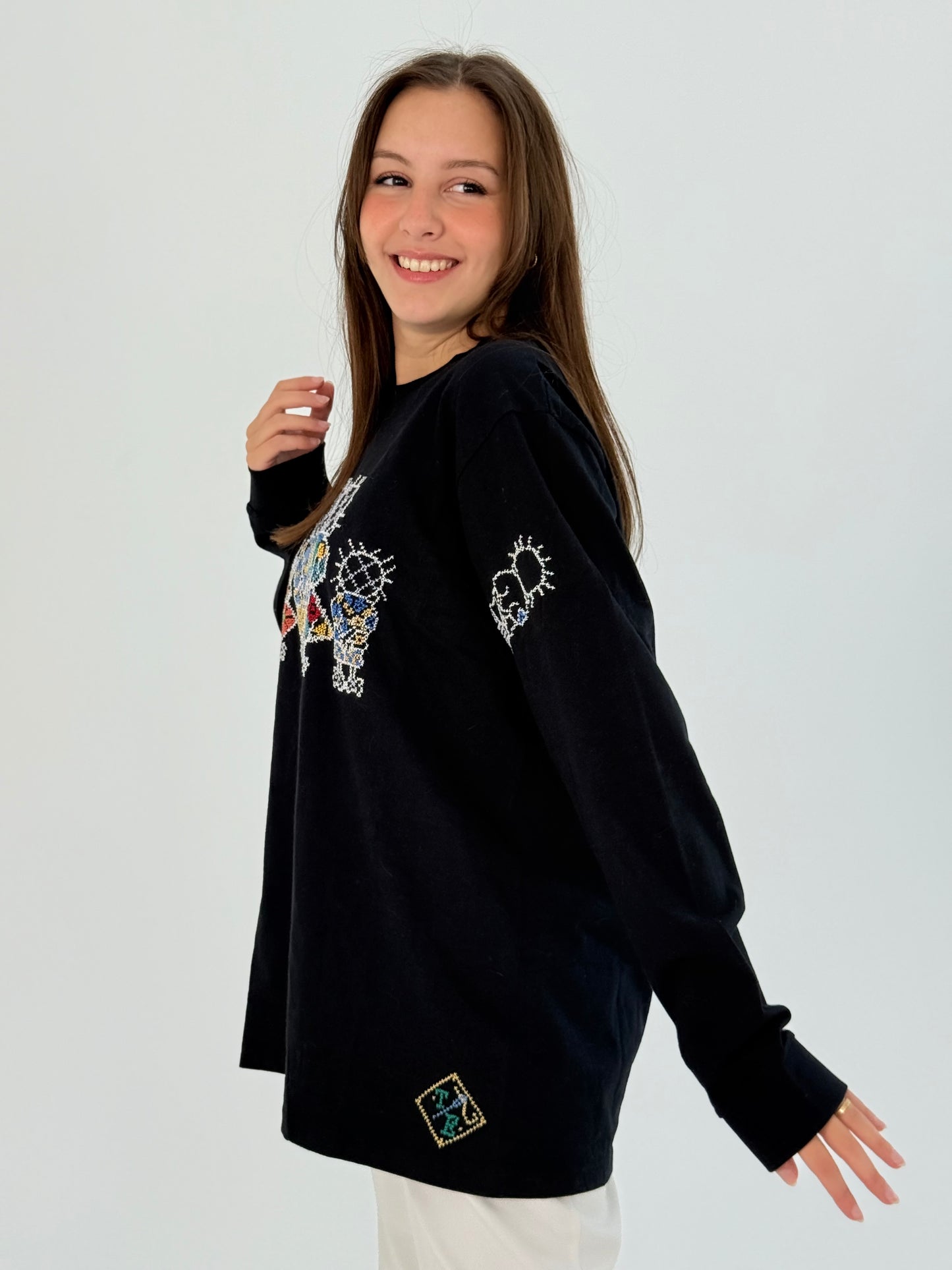 Handmade black cotton long sleeve t-shirt with Handala design, showcasing comfort and cultural significance.