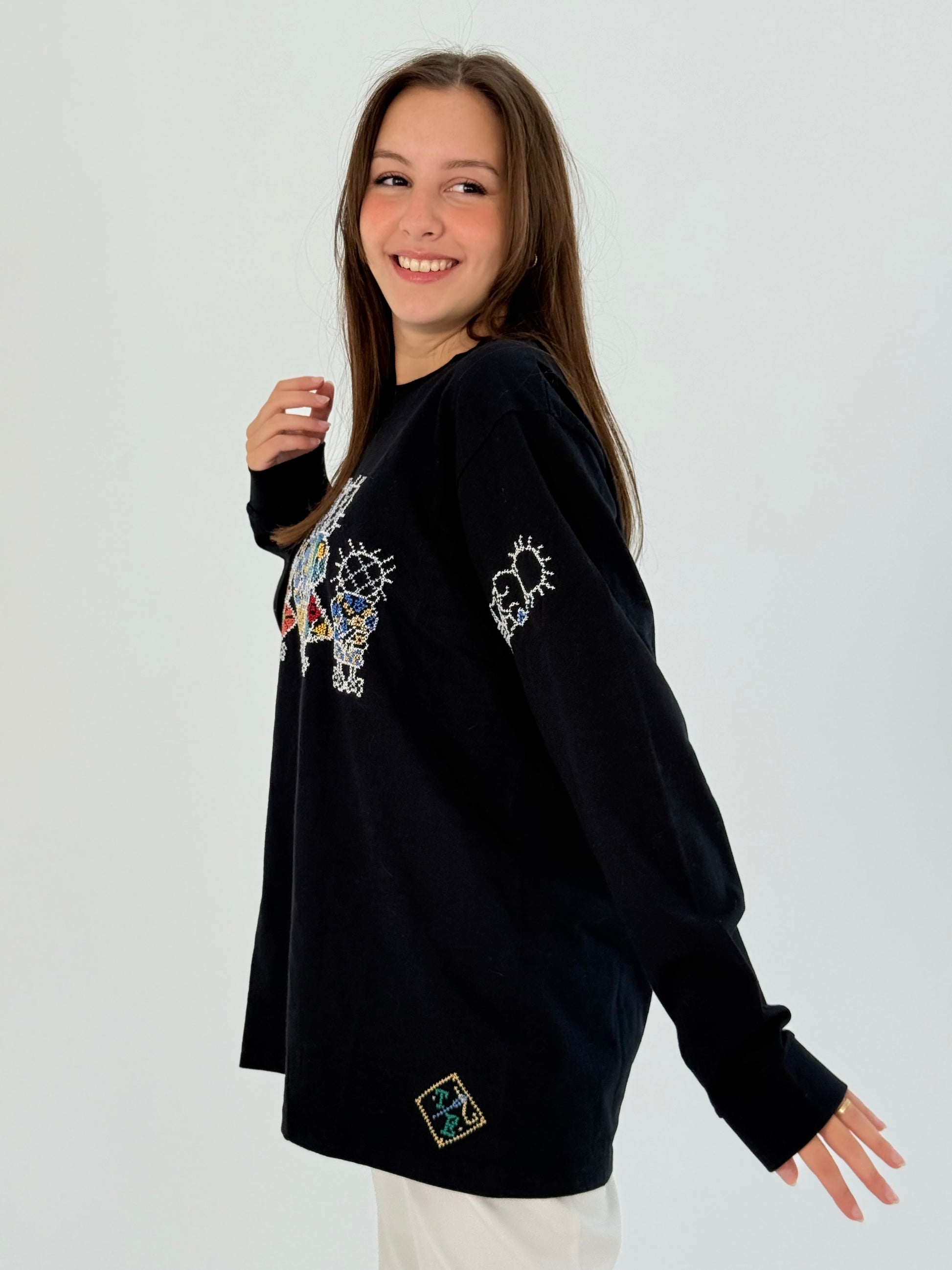 Handmade black cotton long sleeve t-shirt with Handala design, showcasing comfort and cultural significance.