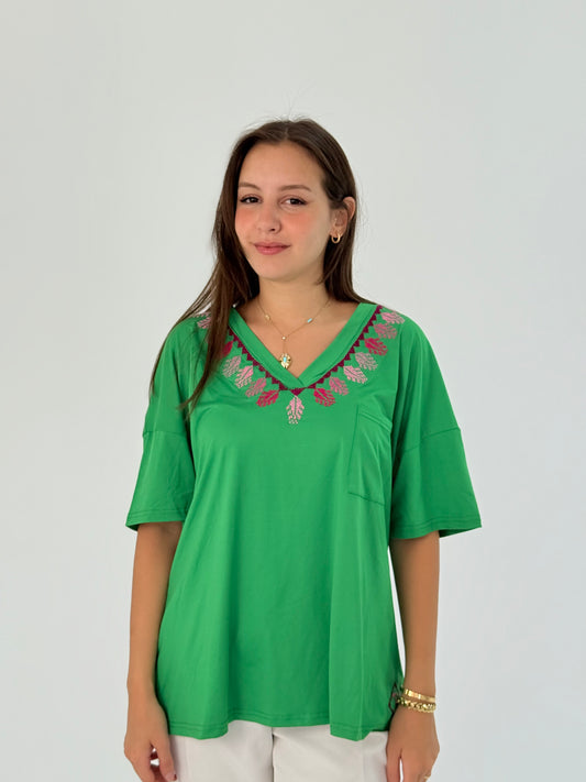 Soft green cotton t-shirt with handmade embroidery on the neck, offering comfort and elegance.