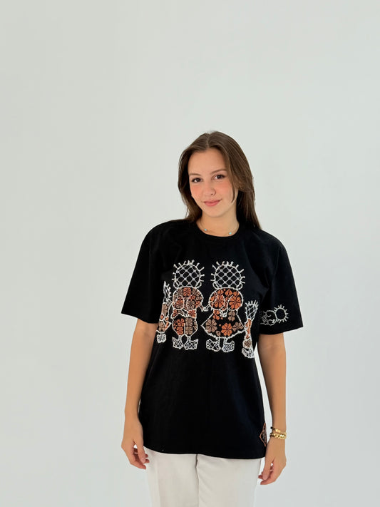 Black cotton T-shirt with Handhala family embroidered in white and beige, featuring iconic pose on the sleeve and brand logo.