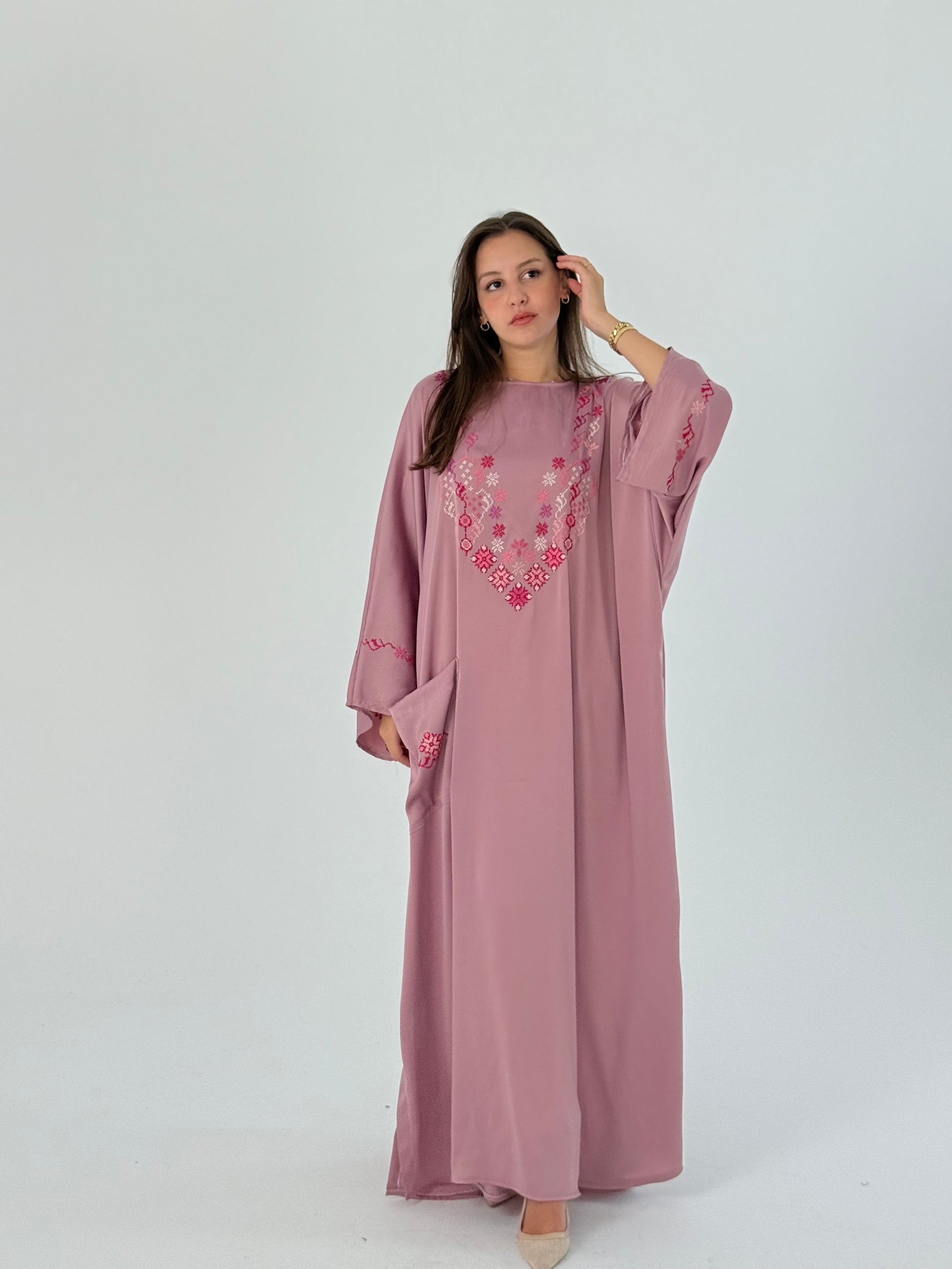Handmade pink abaya in soft silk with elegant embroidery, offering a classy and free-size design.