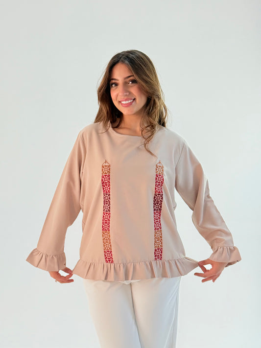 Handmade modern beige long-sleeve top made from crepe georgette, featuring intricate red Palestinian embroidery by resilient Banatna girls, showcased with measurements for sizing.