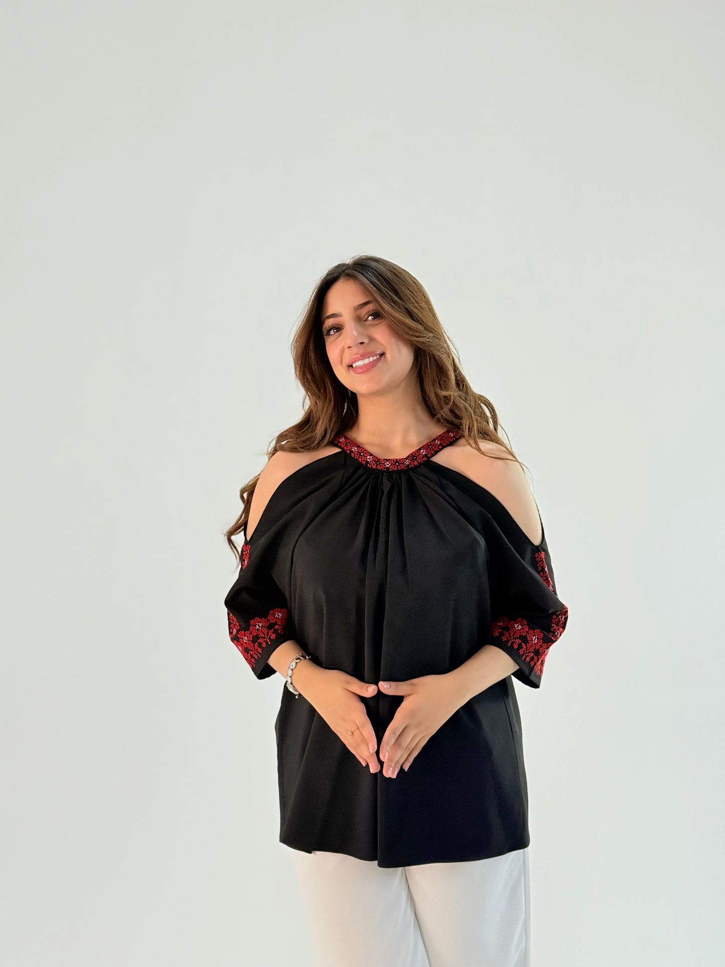 Elegant shoulder-cut top made of twill fabric featuring intricate Palestinian embroidery, showcasing unique design and artisan craftsmanship. Available for customizable pre-orders.