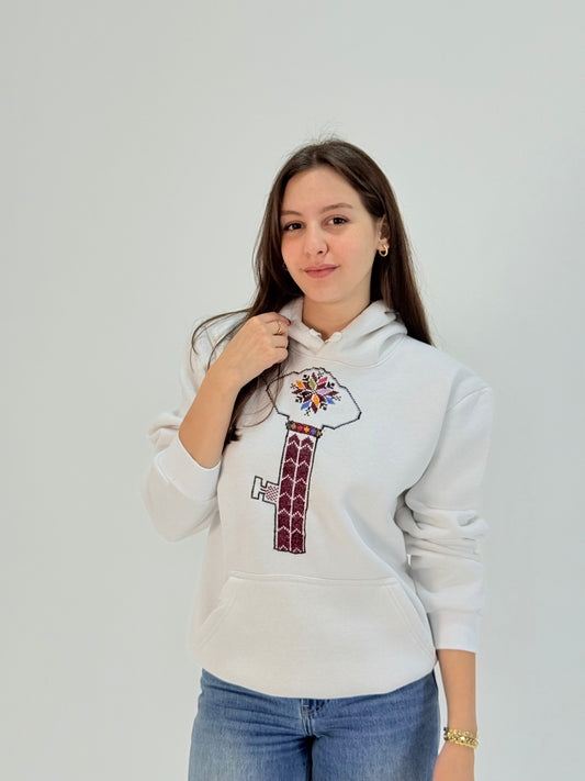 White hoodie with hand-embroidered Key of Return (مفتاح العودة) Palestinian tatreez design, cultural heritage unisex streetwear
