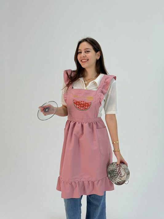 Soft pink waterproof apron with handmade embroidered watermelon design, made by women artisans.