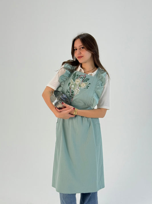 Mint green waterproof apron with handmade embroidered Palestine map, crafted by women artisans.
