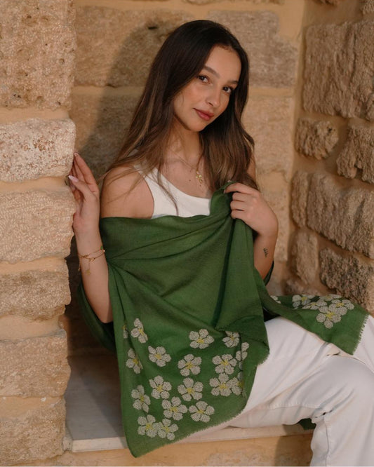 Lightweight pashmina shawl with floral cross-stitch design in pearl white and soft yellow, handcrafted by the Anamilouna Women Empowerment Center in Lebanon.