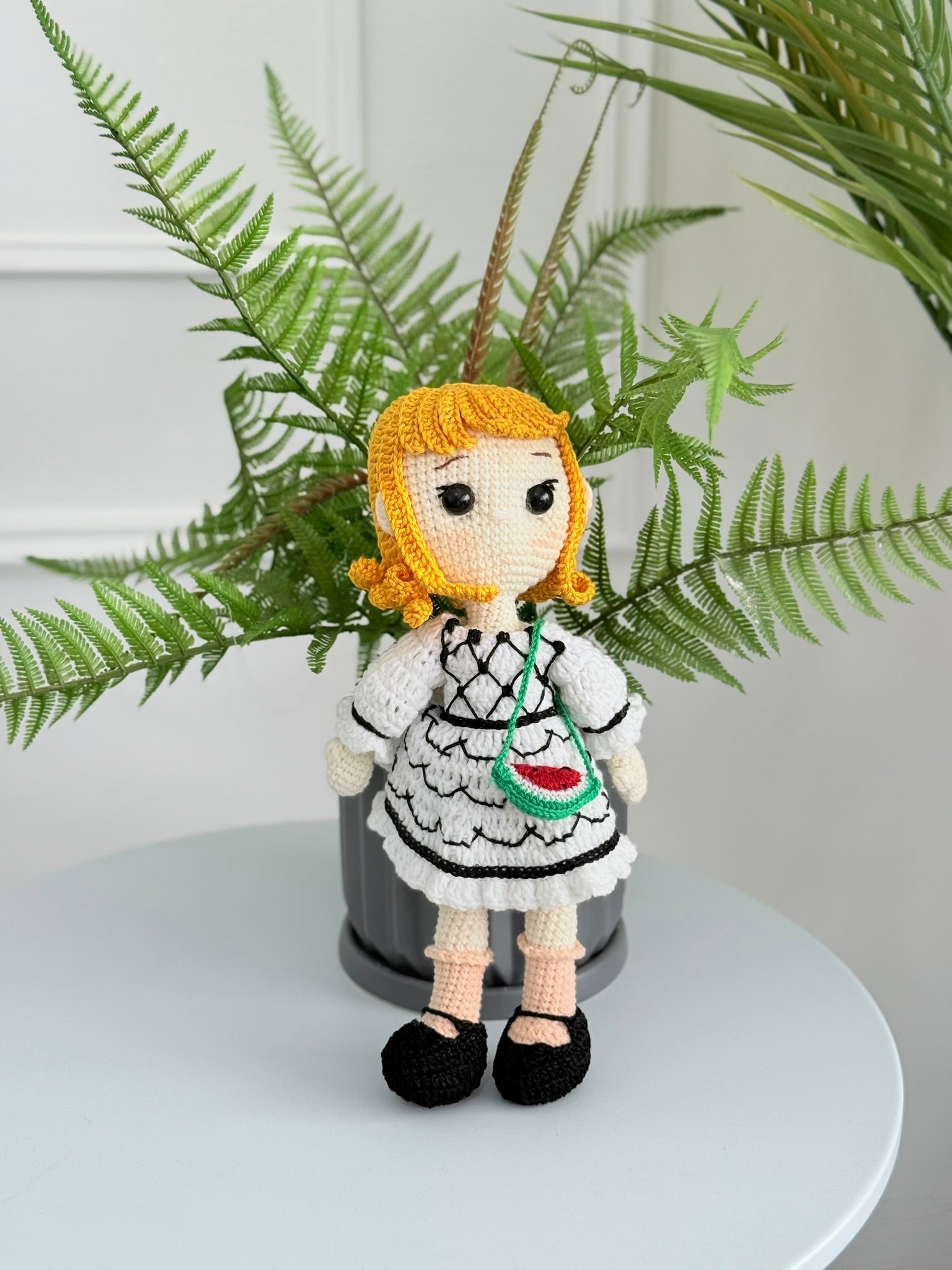 Handmade crochet Palestinian doll wearing kufiyeh-pattern dress, artisan toy supporting Palestinian heritage and culture