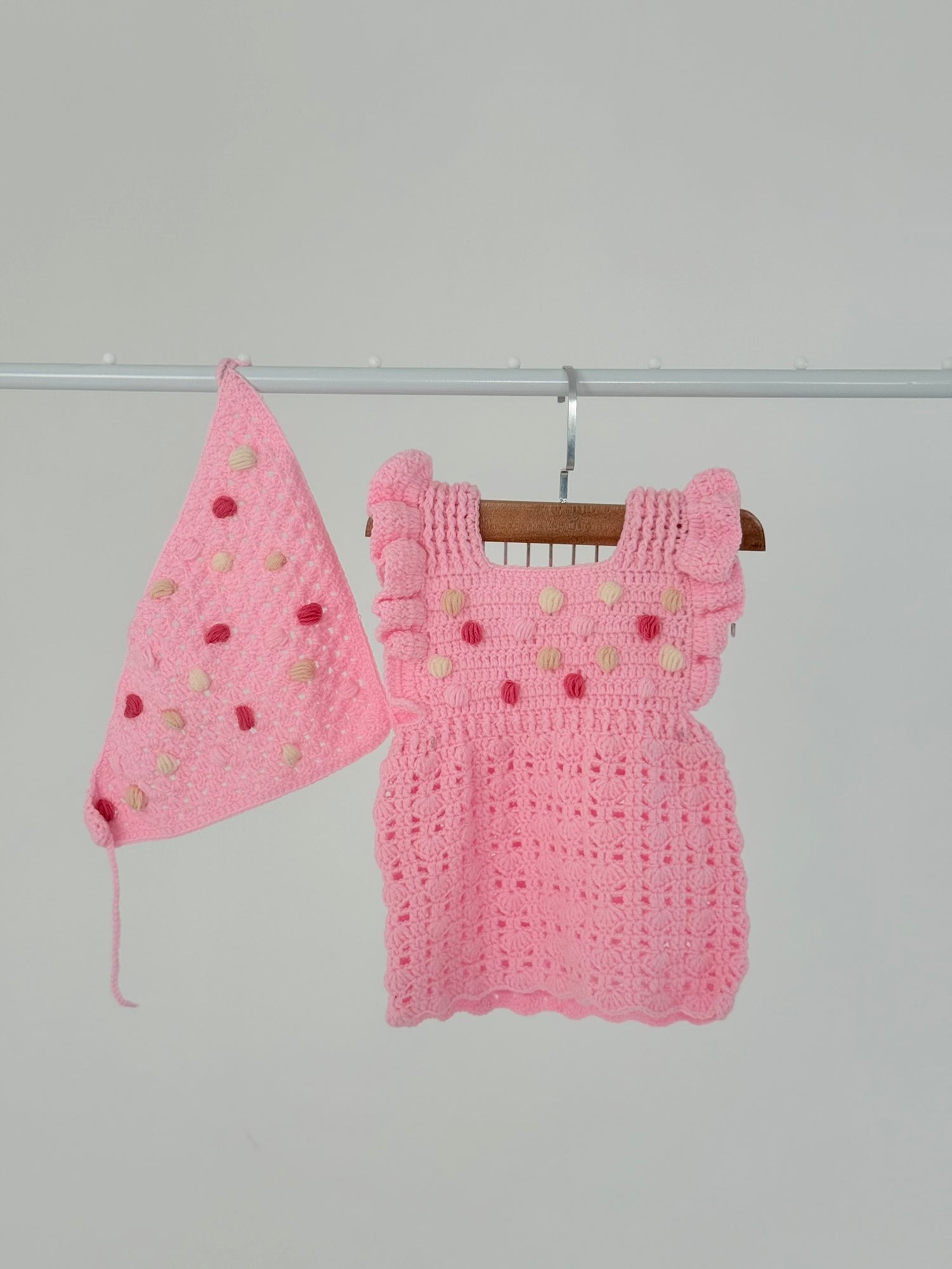 Handmade baby pink crochet dress with matching bandana, crafted by Palestinian women artisans, perfect baby shower or newborn gift.
