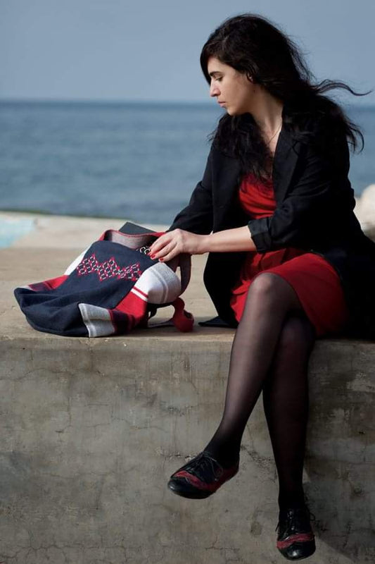 Hand-embroidered linen tote bag in navy with red Palestinian tatreez, limited edition artisan handbag with red striped handles