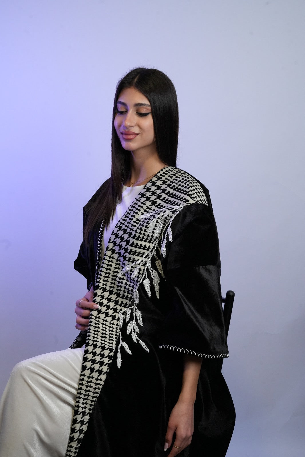 Black velvet thoub with traditional koofeya bead embroidery, handmade by women artisans.
