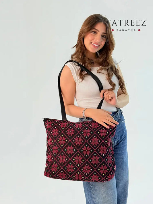 Spacious etamin bag measuring 45.5 cm wide and 39.5 cm long, featuring beautiful burgundy and black tree embroidery, designed for laptops and versatile storage, combining elegance and practicality for resilient ladies.