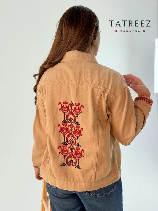 Beige jeans jacket adorned with beautiful handmade floral embroidery, showcasing unique artisan craftsmanship.
