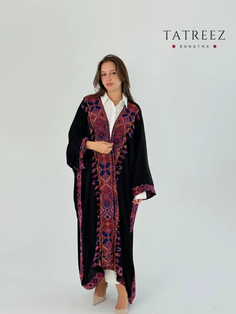 Woman wearing a handmade embroidered crepe georgette Bisht with a floral design.