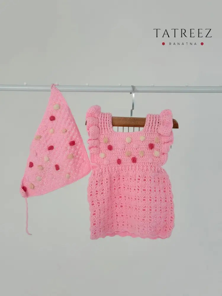 Handmade baby pink crochet dress with matching bandana, crafted by Palestinian women artisans, perfect baby shower or newborn gift.