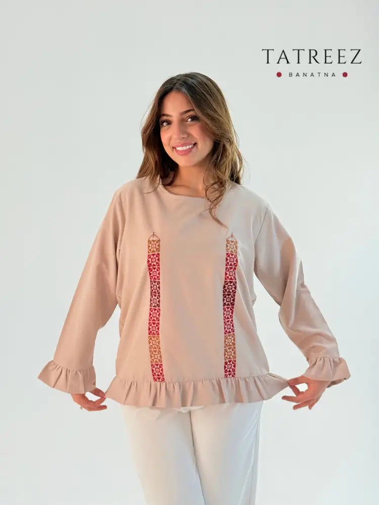 Handmade modern beige long-sleeve top made from crepe georgette, featuring intricate red Palestinian embroidery by resilient Banatna girls, showcased with measurements for sizing.