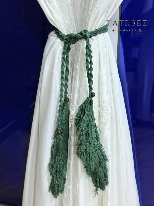 Handmade crochet curtain holders with tassels in green and cream, crafted by Palestinian women artisans, perfect for boho home decor.