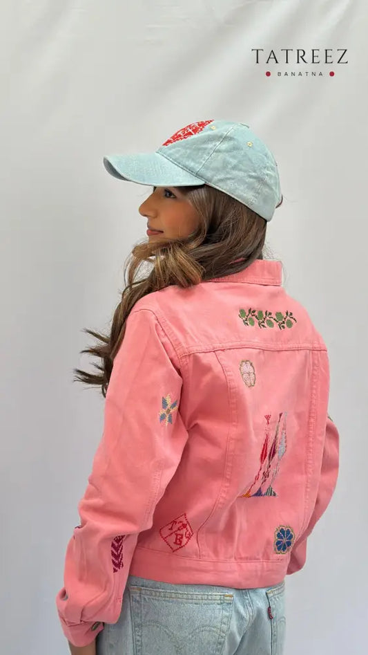 Handmade pink jeans jacket featuring Palestinian heritage motifs, modeled in large size, showcasing cultural craftsmanship