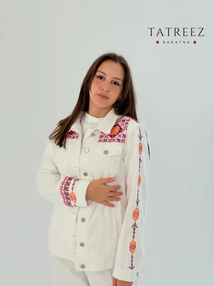 Handmade white jeans jacket with red embroidery on shoulders, sleeves, and front, blending modern and traditional beauty.