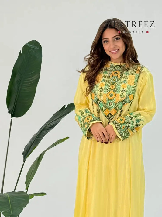 Jasmine Abaya: Handmade yellow chiffon abaya with green embroidery, designed for elegance and customizable for every occasion, crafted by skilled artisans in Jordan.