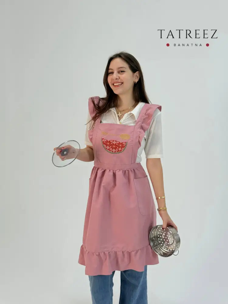 Soft pink waterproof apron with handmade embroidered watermelon design, made by women artisans.