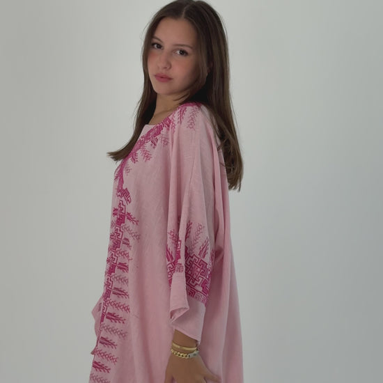 Handmade soft pink linen abaya featuring intricate Tatreez embroidery, combining elegance and comfort.