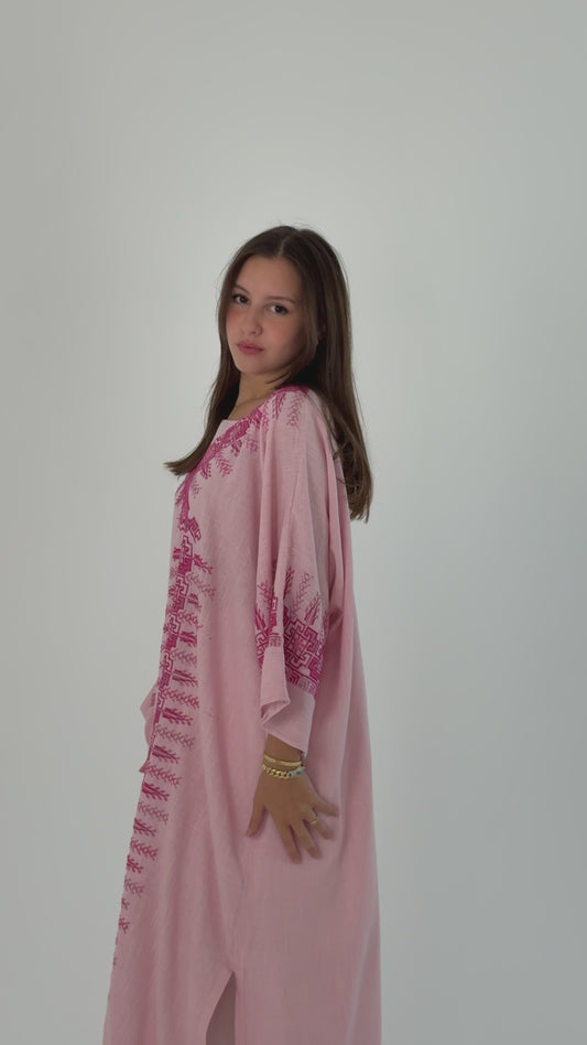 Handmade soft pink linen abaya featuring intricate Tatreez embroidery, combining elegance and comfort.