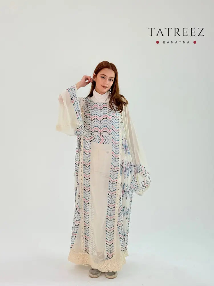 Elegant handmade beige abaya with intricate crochet detailing and beautiful embroidery, modeled by a woman 170 cm tall