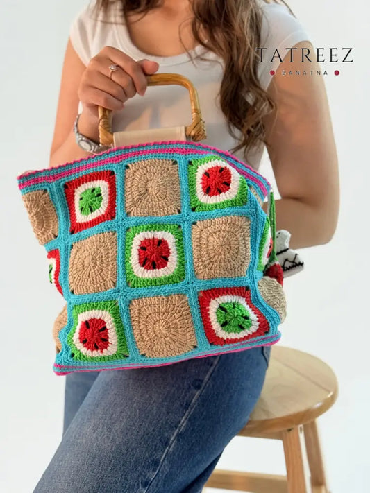 Medium-sized watermelon crochet bag in vibrant red, green, and beige cotton, featuring a wooden handle and cute kofea dress design.