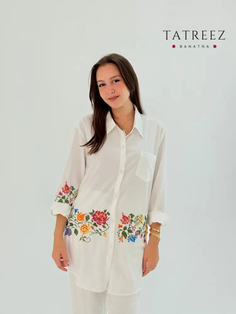 Handmade white shirt made of polin fabric with elegant floral embroidery on the bottom.