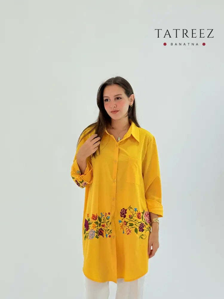 Handmade yellow shirt made of polin fabric with elegant floral embroidery on the bottom.