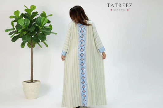 Zahra Abaya: Handmade baby blue striped satin and Cornish satin fabric abaya with elegant embroidery on the front and back, designed for sophistication and customizable for every occasion, perfect for enhancing a woman's beauty.